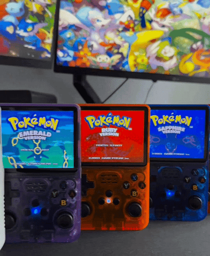 Colorful handheld gaming consoles displaying Pokemon Emerald, Ruby, and Sapphire versions.